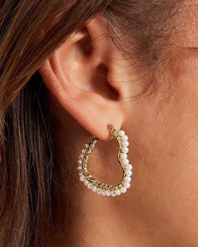 Hartjes vormige oorbel met parels - goud